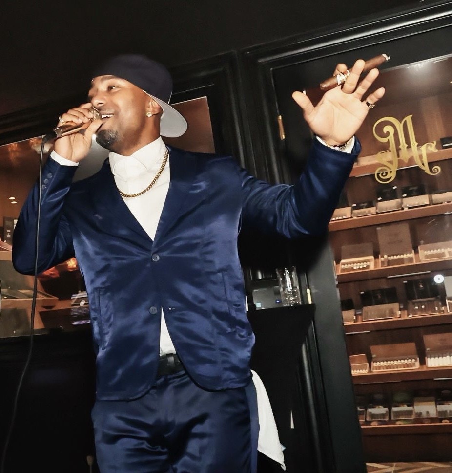 Zieme performing live on stage in a blue satin suit